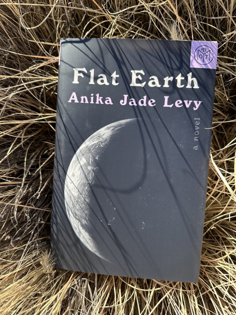 The cover of Flat Earth by Anika Jade Levy shows a waning sliver of moon