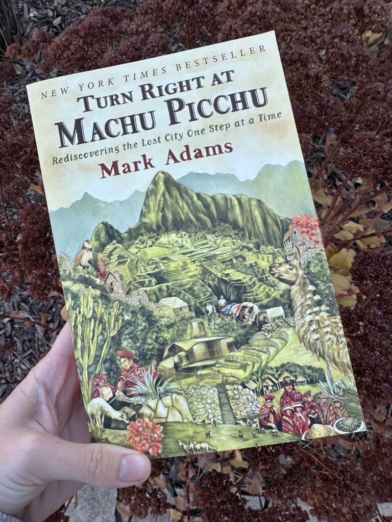 The cover of Turn Right at Machu Picchu by Mark Adams shows the famous ruins in a drawing as they may have appeared with Incas living there