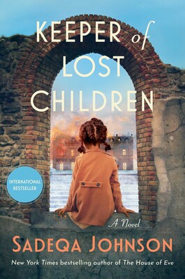 The cover of The Keeper of Lost Children by Sadeqa Johnson shows a child sitting facing away from the viewer in the window of a ruin, looking at a burning building in the background