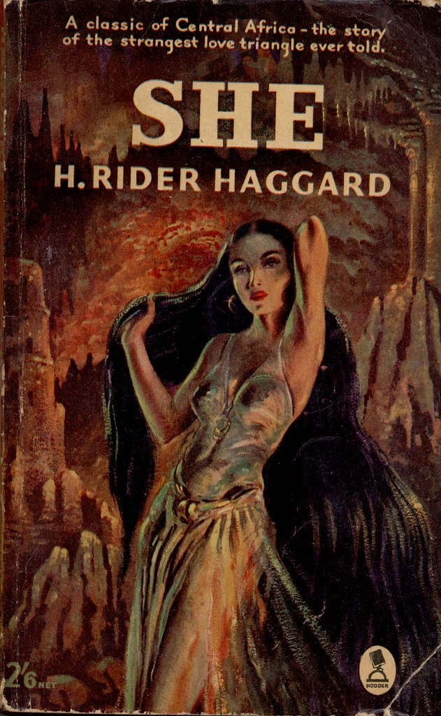 The cover of She shows a sensual woman removing what looks like a cloak or veil in a cave. 