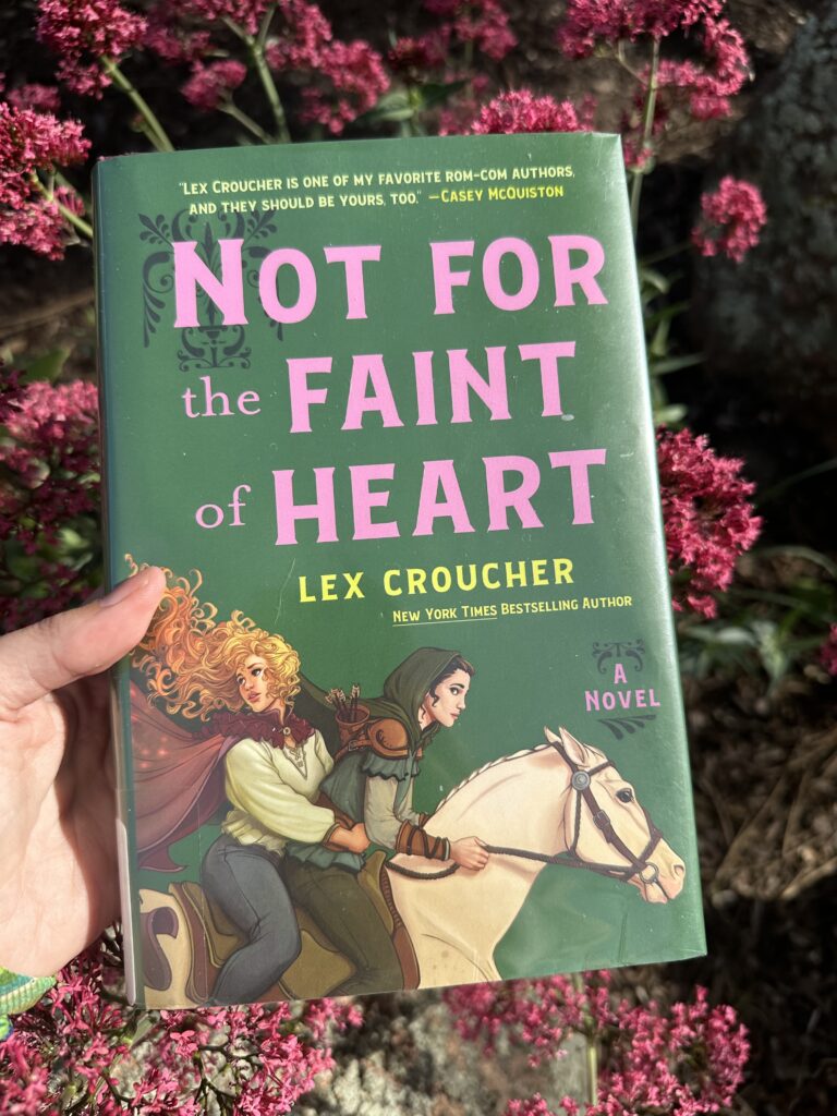 The cover of Not for the Faint of Heart shows two girls dressed in Robin Hood type clothes riding a white horse.